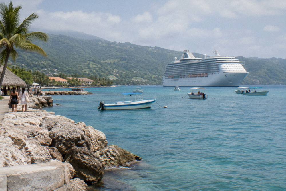 Travelers arriving at a tropical cruise port terminal in daylight