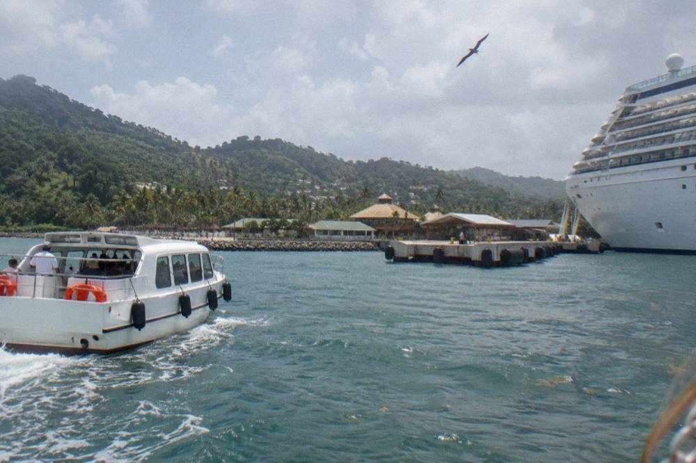 Cruise tender boat approaching a Caribbean port pier in morning light