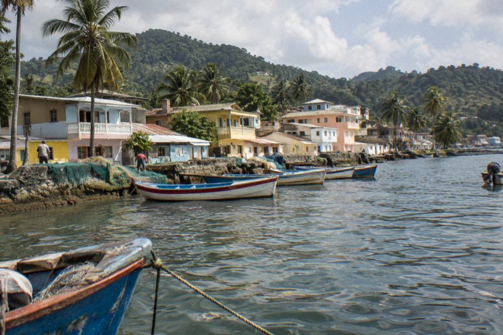 A small coastal town waterfront with boats at rest in a bay